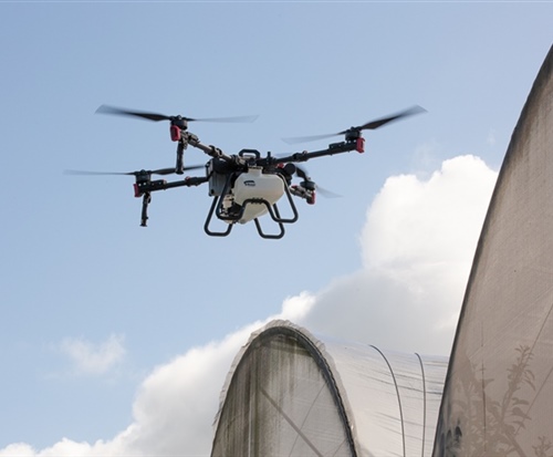 drone applying chemicals in orchard