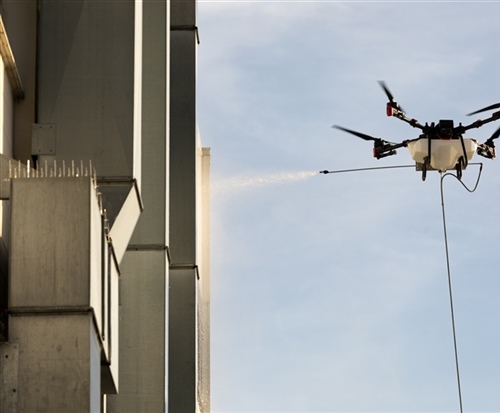 Drone water blasting of a large commercial building for an instant clean