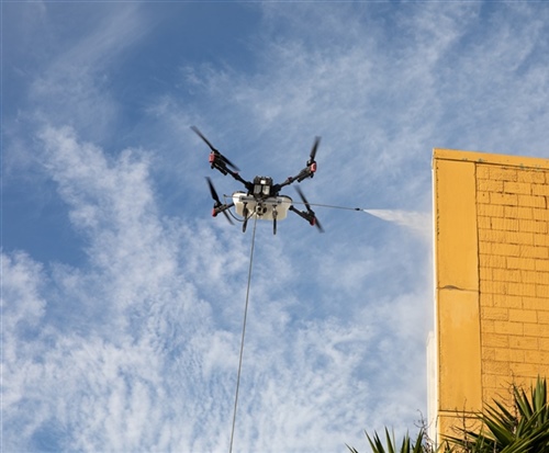Drone water blasting of a large commercial building for an instant clean