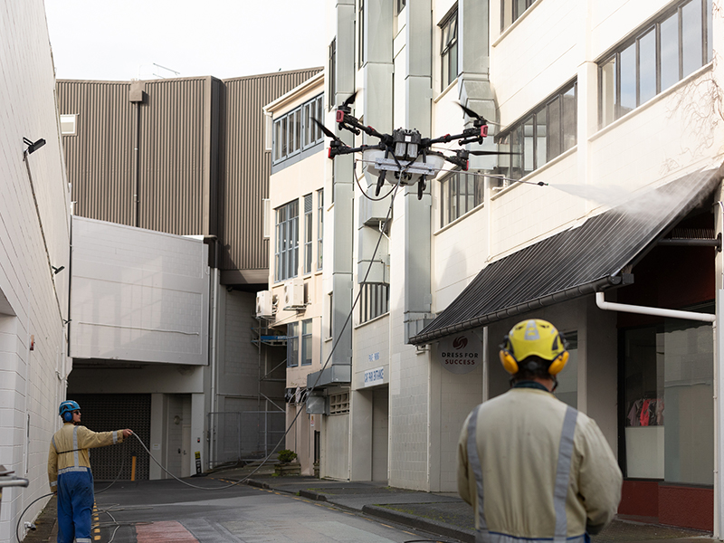 Drone Water Blasting cleaning a building in central Whangarei